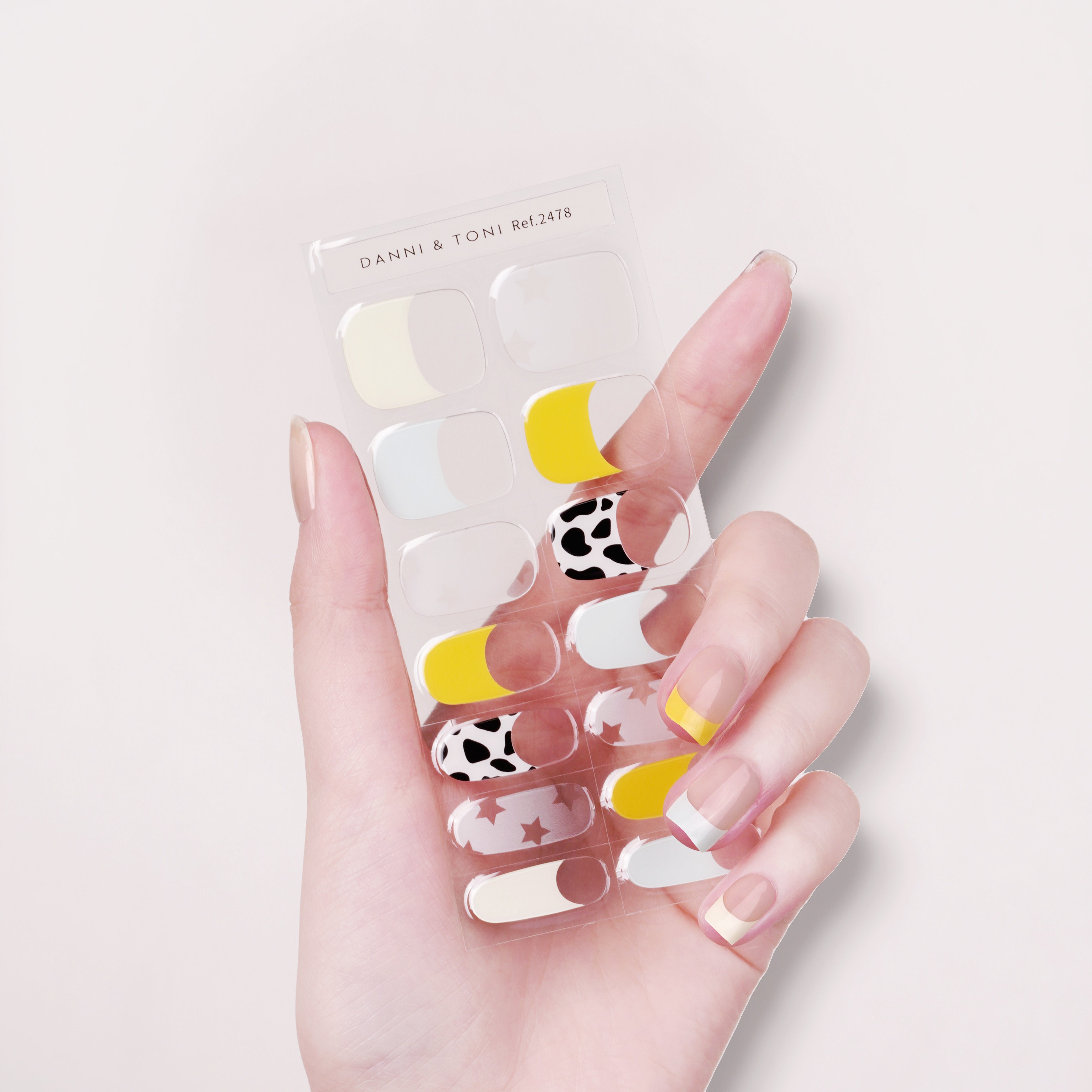 Chic Playful French Tip Semi cured gel nail strips with Cow Print Accent | Cosmic Mosaic - 2478